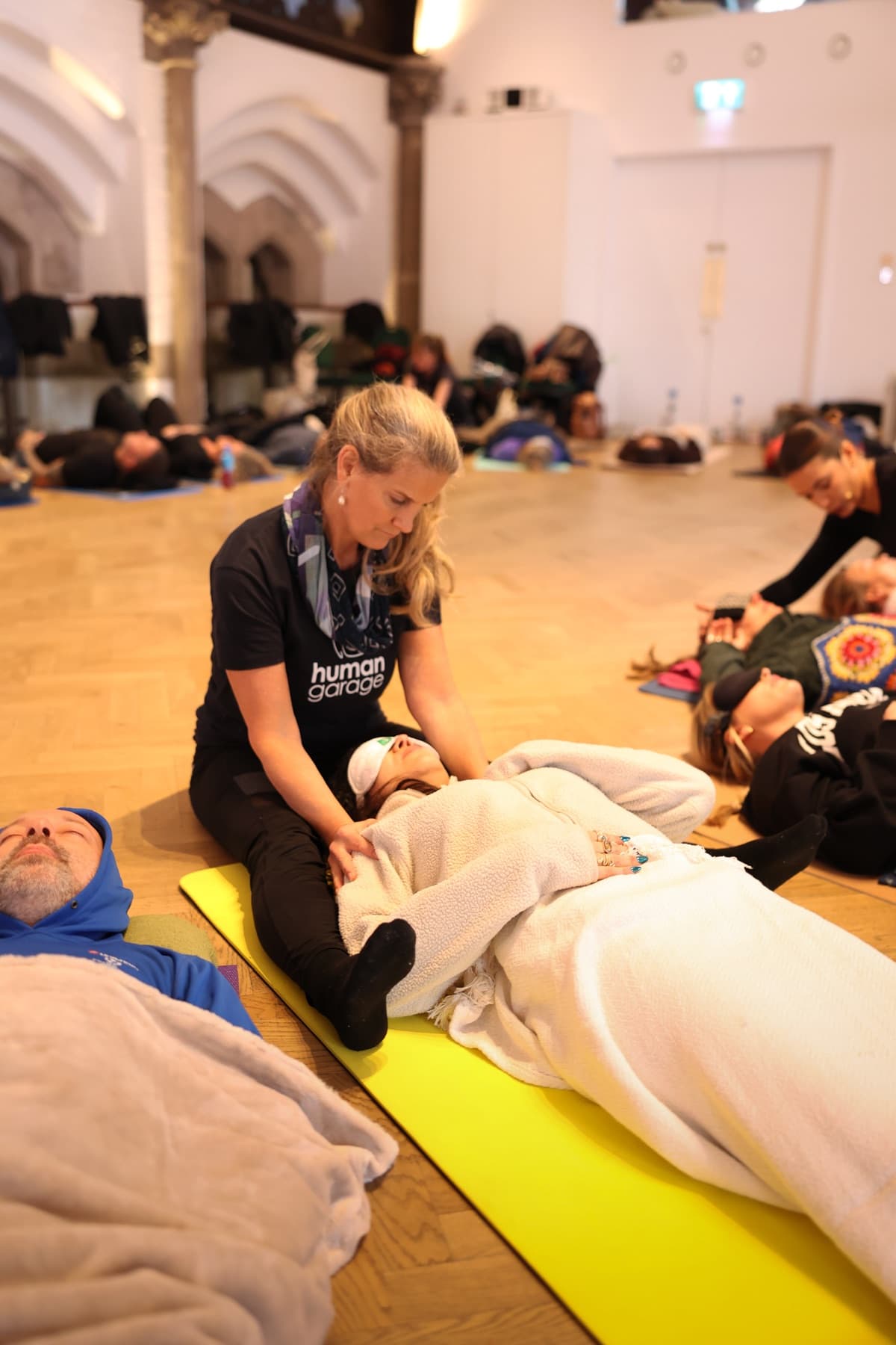 Carolyn Wade supporting a participant during a body-based reset session
